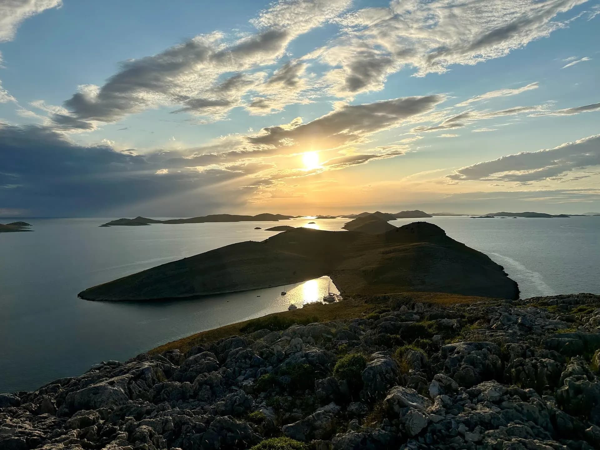 Sunset over islands seen from a rocky ridge hike